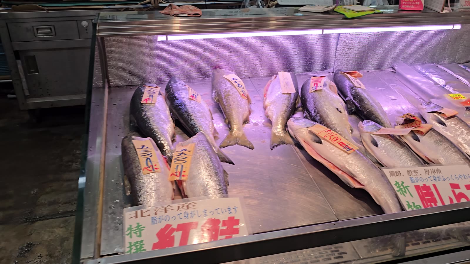 Whole salmon on ice at a fishmonger in Washo Market